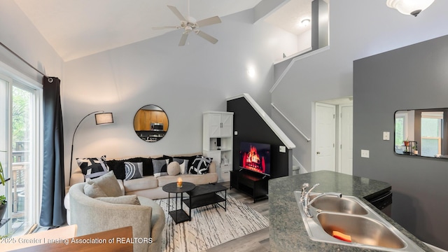 13799 Mead Creek Rd Unit 63D, Bath, MI 48808 - living area featuring high vaulted ceiling, stairway, wood finished floors, and a ceiling fan