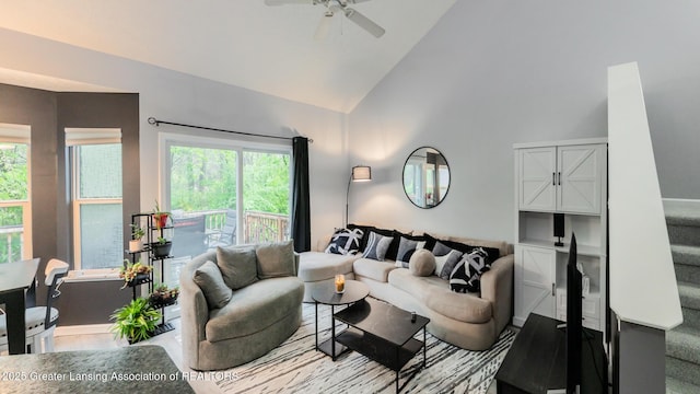 13799 Mead Creek Rd Unit 63D, Bath, MI 48808 - living area featuring a ceiling fan, healthy amount of natural light, high vaulted ceiling, and stairs