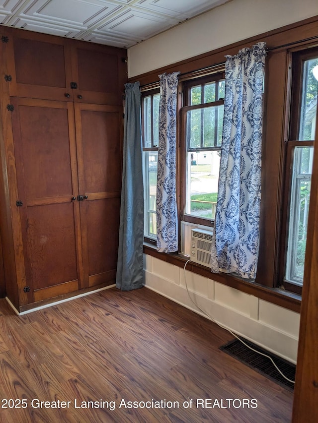 empty room with visible vents and wood finished floors