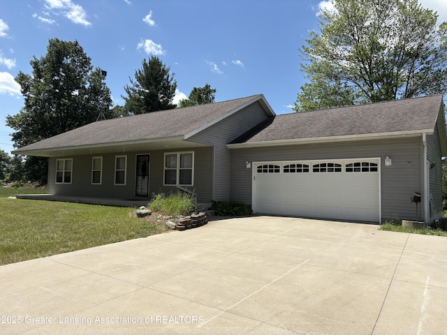 5205 N Bailey Rd, Coral, MI 49322 - single story home with driveway, an attached garage, a front yard, and a shingled roof