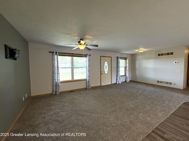 5205 N Bailey Rd, Coral, MI 49322 - unfurnished living room featuring a ceiling fan and carpet floors
