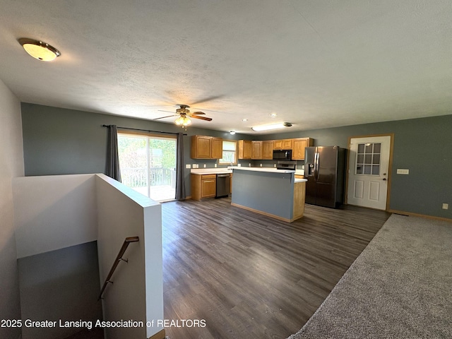 5205 N Bailey Rd, Coral, MI 49322 - kitchen with stainless steel appliances, light countertops, a center island, dark wood finished floors, and recessed lighting