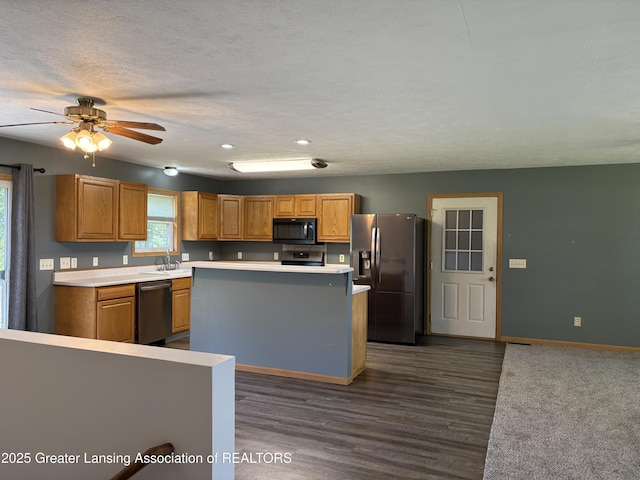 5205 N Bailey Rd, Coral, MI 49322 - kitchen featuring appliances with stainless steel finishes, a center island, light countertops, and dark wood-style floors