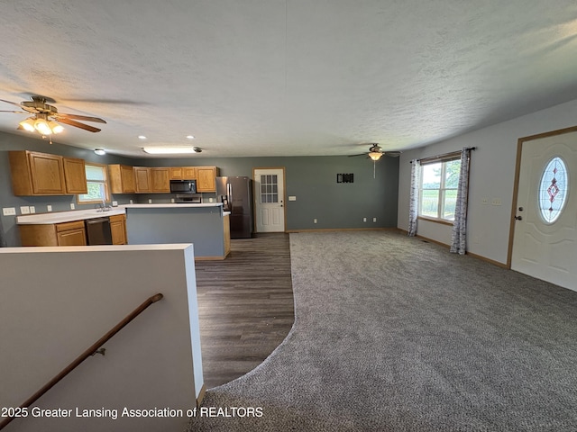 5205 N Bailey Rd, Coral, MI 49322 - unfurnished living room featuring ceiling fan, a textured ceiling, recessed lighting, and dark wood-style flooring