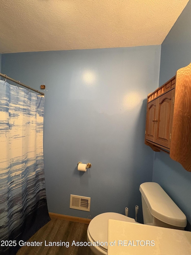 5205 N Bailey Rd, Coral, MI 49322 - full bathroom with wood finished floors, a textured ceiling, and curtained shower