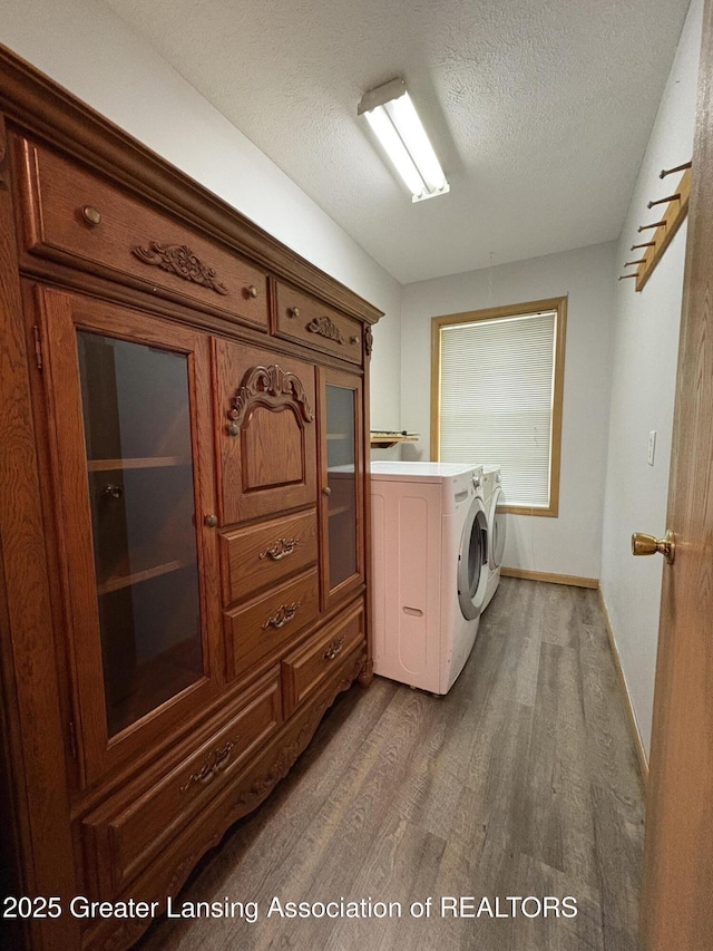 5205 N Bailey Rd, Coral, MI 49322 - washroom featuring independent washer and dryer, dark wood-style flooring, and a textured ceiling