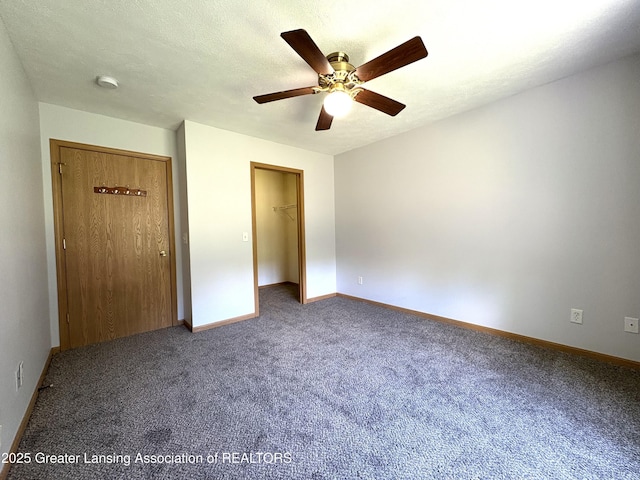 5205 N Bailey Rd, Coral, MI 49322 - unfurnished bedroom with carpet flooring, a ceiling fan, a closet, and a spacious closet