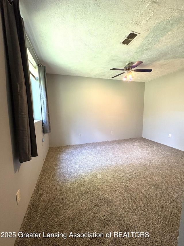5205 N Bailey Rd, Coral, MI 49322 - carpeted empty room with ceiling fan and a textured ceiling