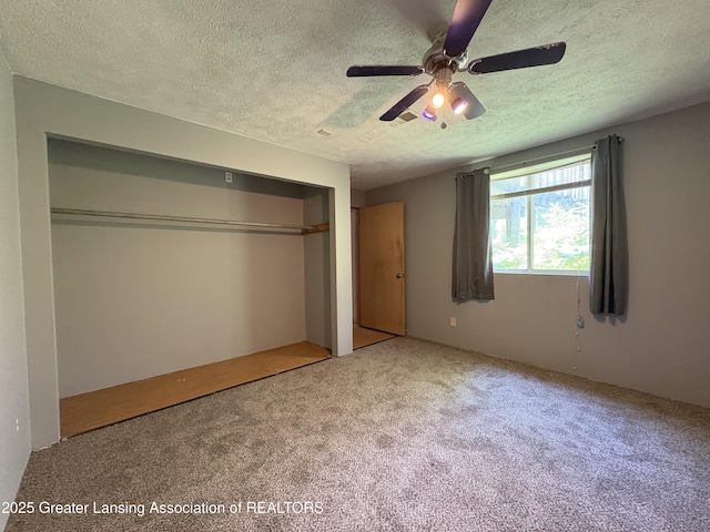 5205 N Bailey Rd, Coral, MI 49322 - unfurnished bedroom with carpet floors, a textured ceiling, a closet, and a ceiling fan