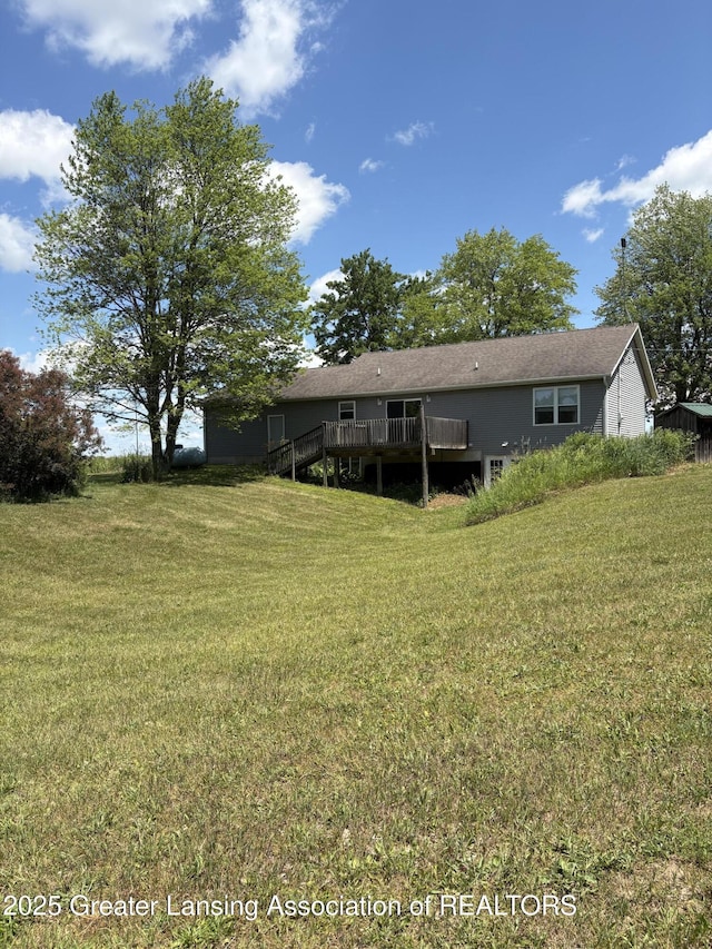 5205 N Bailey Rd, Coral, MI 49322 - back of property featuring a wooden deck and a lawn