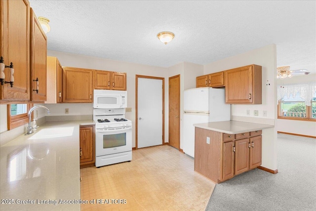kitchen with a textured ceiling, white appliances, a sink, brown cabinets, and light countertops