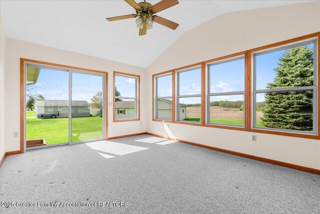 unfurnished sunroom with baseboards, lofted ceiling, and carpet floors