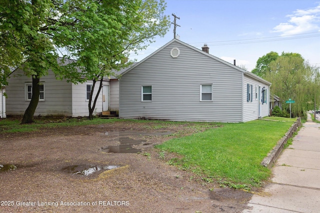 1406 N Martin Luther King Jr Blvd, Lansing, MI 48915 - view of side of home featuring a yard