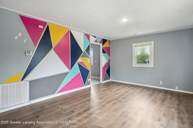 1406 N Martin Luther King Jr Blvd, Lansing, MI 48915 - interior space featuring a textured ceiling, baseboards, visible vents, and wood finished floors