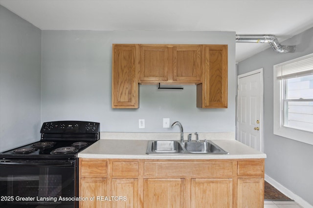 1406 N Martin Luther King Jr Blvd, Lansing, MI 48915 - kitchen featuring tile patterned floors, light countertops, black / electric stove, and a sink