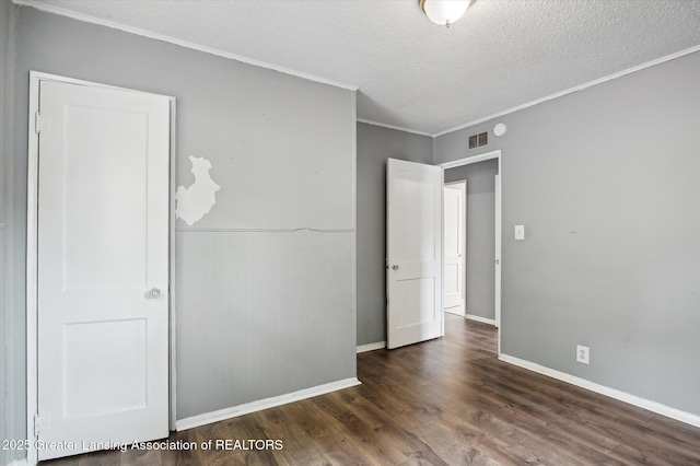 1406 N Martin Luther King Jr Blvd, Lansing, MI 48915 - unfurnished bedroom with wood finished floors, crown molding, a textured ceiling, visible vents, and baseboards