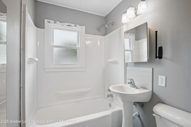 1406 N Martin Luther King Jr Blvd, Lansing, MI 48915 - bathroom with toilet, crown molding, and tub / shower combination