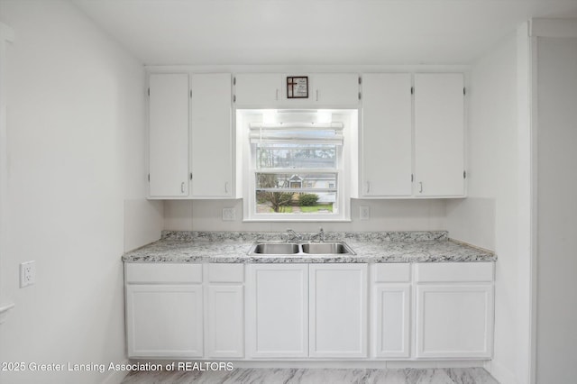 900 Holten St, Lansing, MI 48915 - kitchen with white cabinets, light countertops, and a sink