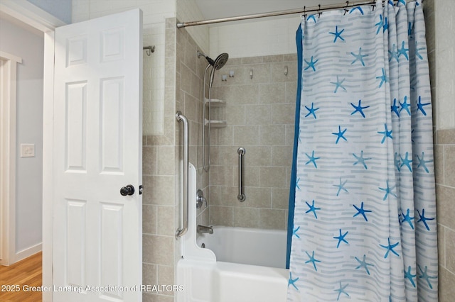 900 Holten St, Lansing, MI 48915 - bathroom featuring shower / bath combination with curtain and wood finished floors
