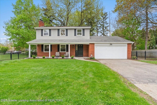 traditional-style house with fence, an attached garage, a chimney, and driveway