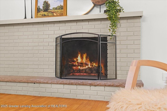 interior details with a fireplace and wood finished floors