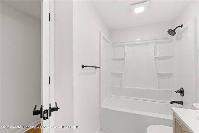 bathroom featuring shower / bathtub combination, vanity, toilet, and baseboards