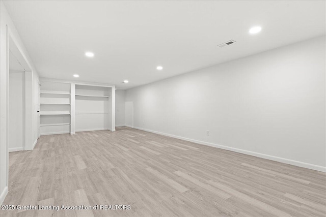 interior space with light wood-type flooring, visible vents, and recessed lighting