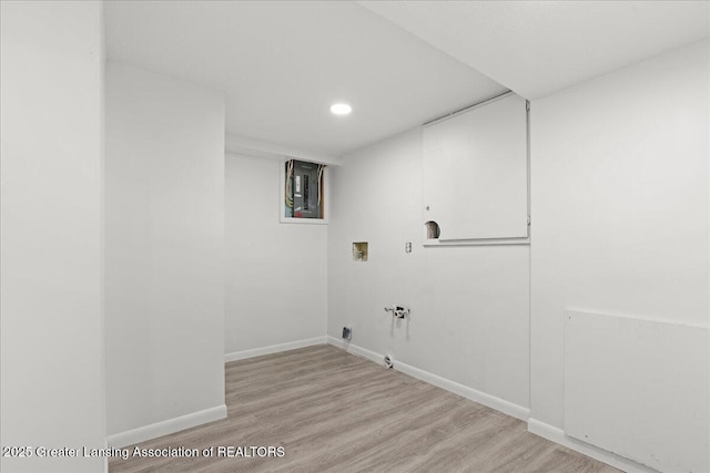 clothes washing area featuring baseboards, gas dryer hookup, light wood-style floors, and washer hookup