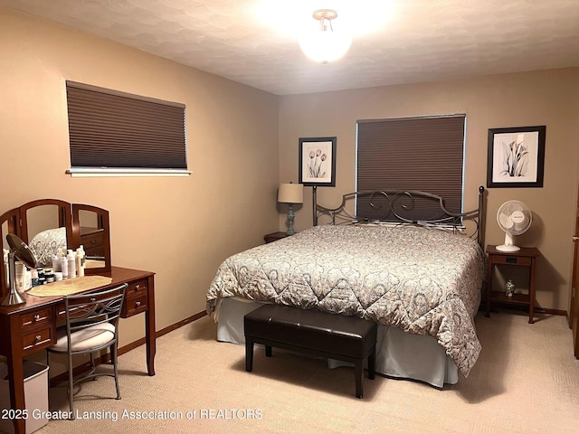 bedroom with carpet floors and baseboards
