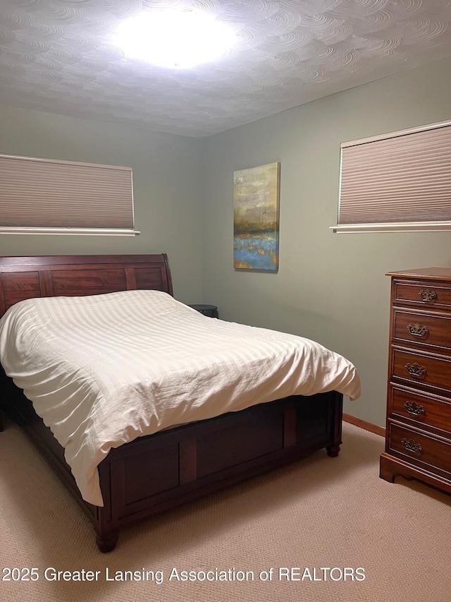 carpeted bedroom featuring baseboards