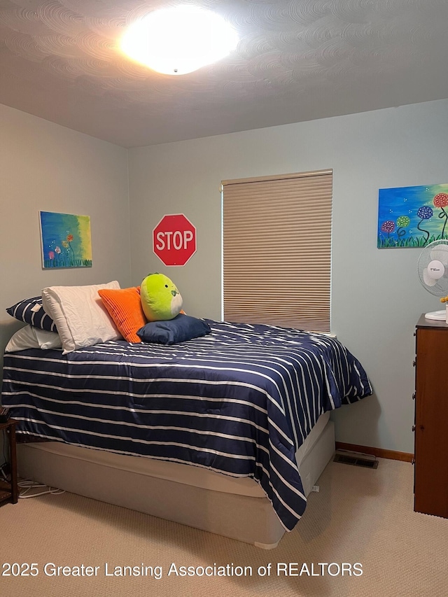carpeted bedroom with baseboards
