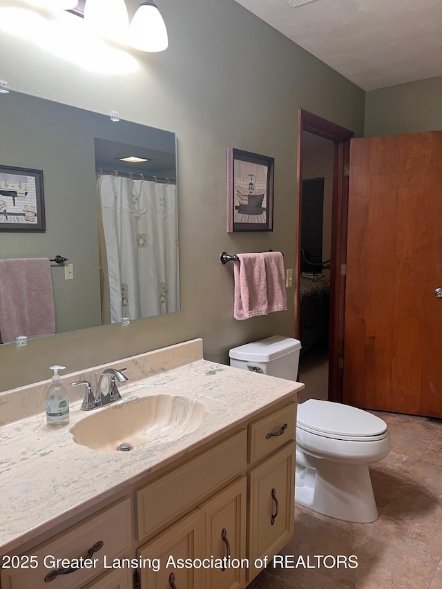 full bath featuring toilet and vanity