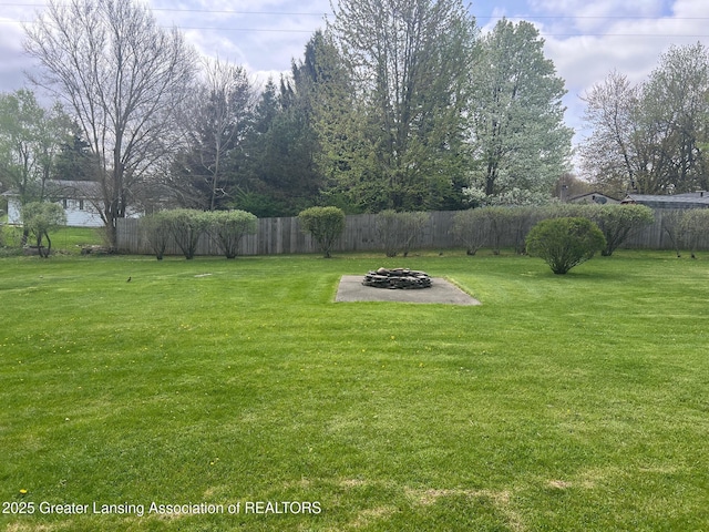 view of yard with a fire pit and a patio area