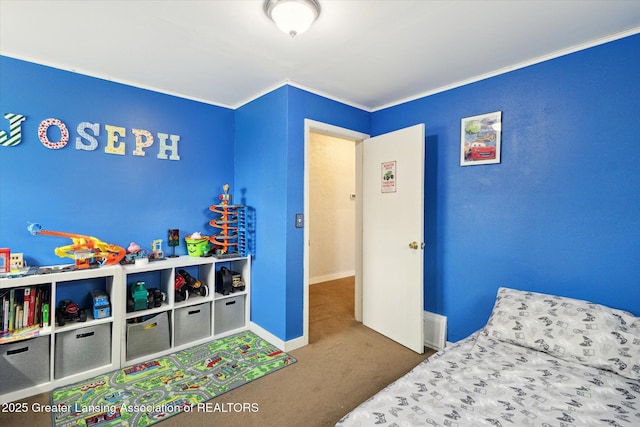 carpeted bedroom featuring crown molding and baseboards
