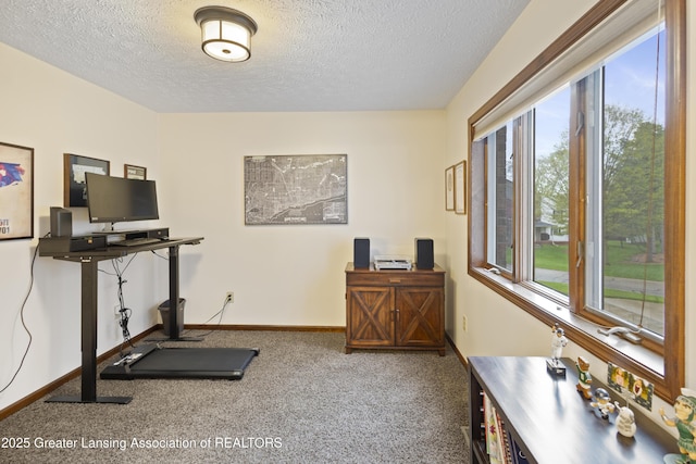 workout area with carpet, a textured ceiling, and baseboards