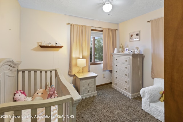 bedroom with dark carpet, a textured ceiling, and baseboards