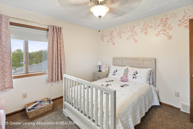 bedroom with carpet flooring, a textured ceiling, baseboards, and ceiling fan