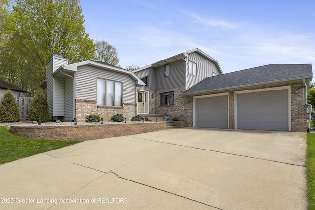 view of front of house featuring brick siding, an attached garage, driveway, a chimney, and a shingled roof