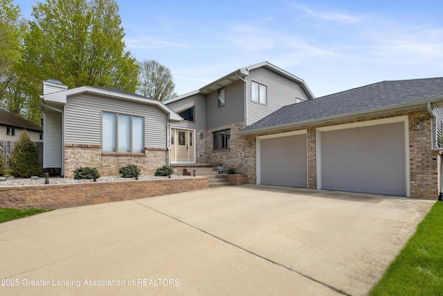 view of front of home with brick siding, an attached garage, concrete driveway, a chimney, and roof with shingles