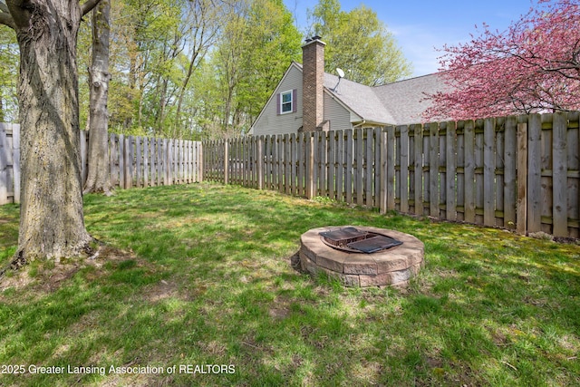 view of yard with an outdoor fire pit