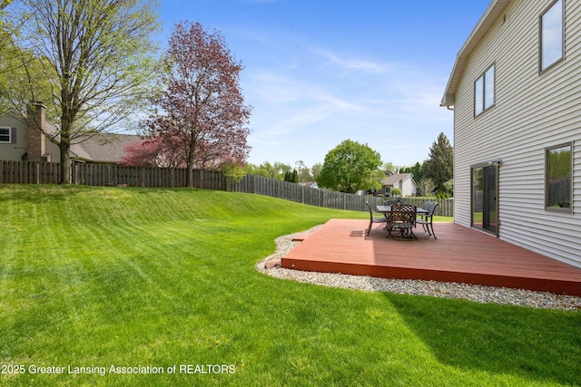 view of yard featuring a deck and outdoor dining area