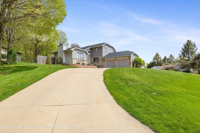 view of front facade with concrete driveway, a front lawn, and a garage