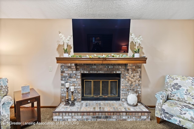 detailed view of a fireplace, carpet flooring, baseboards, and a textured ceiling