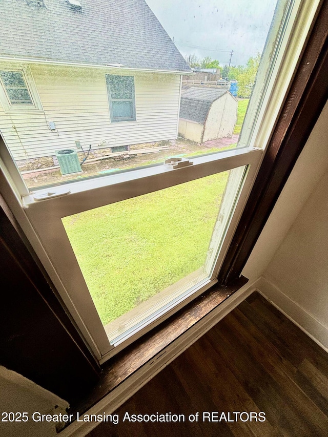 room details featuring baseboards and wood finished floors