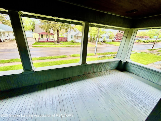 unfurnished sunroom with a residential view