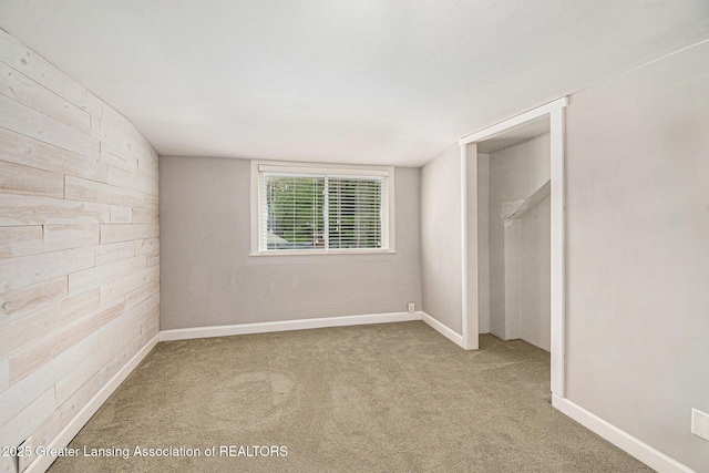 unfurnished bedroom with carpet, baseboards, and a closet
