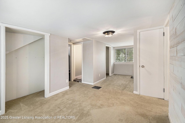 unfurnished bedroom with baseboards and light colored carpet