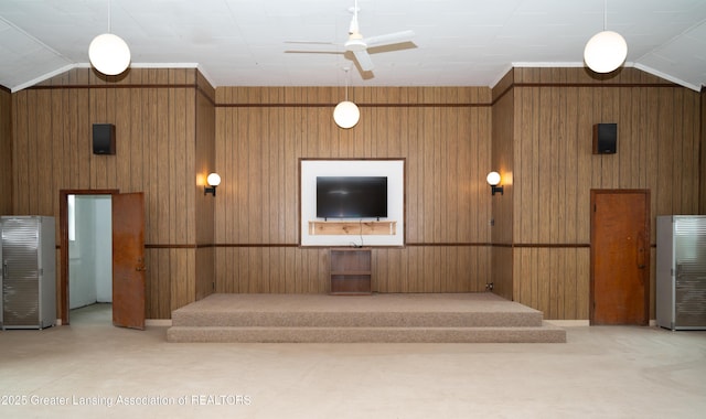 reception with wood walls, ceiling fan, and lofted ceiling