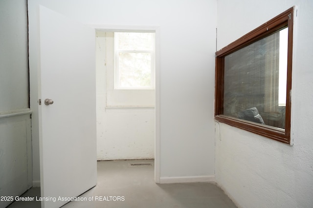 corridor with concrete flooring