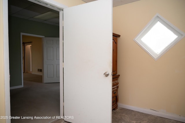 corridor with carpet flooring and baseboards
